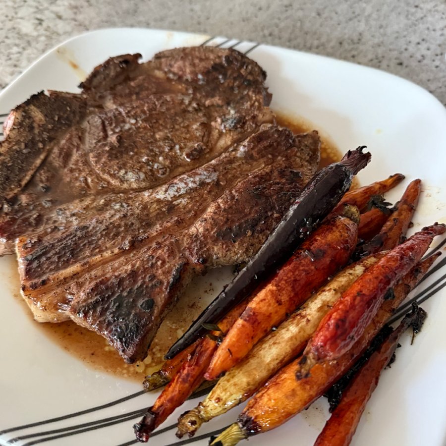 Seared steak served with roasted carrots